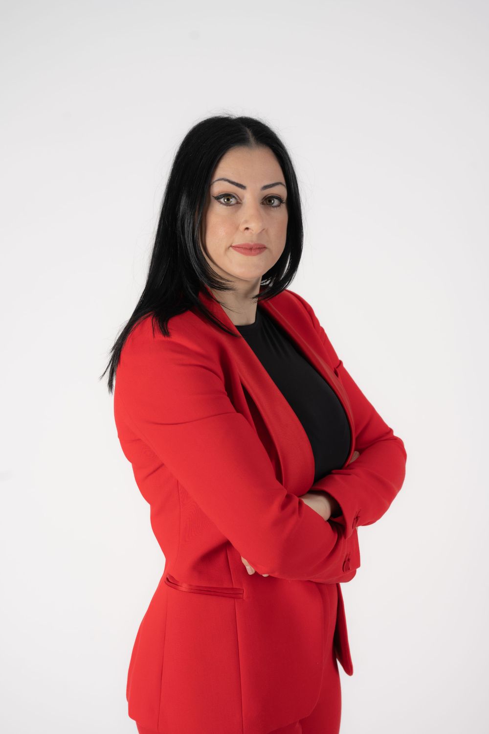 Professional portrait series against white background wearing bright red blazer.