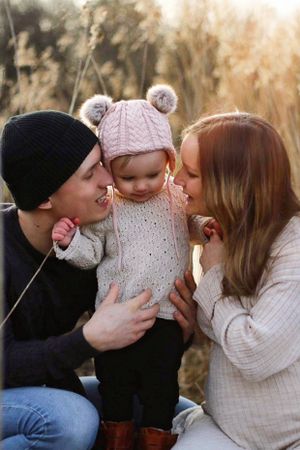 Family sharing intimate moment together outdoors during golden hour.