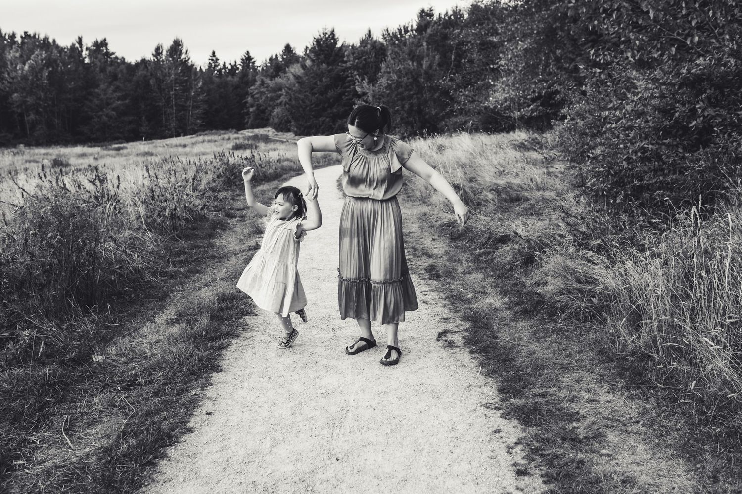 Black and white photo of auntie twirling niece