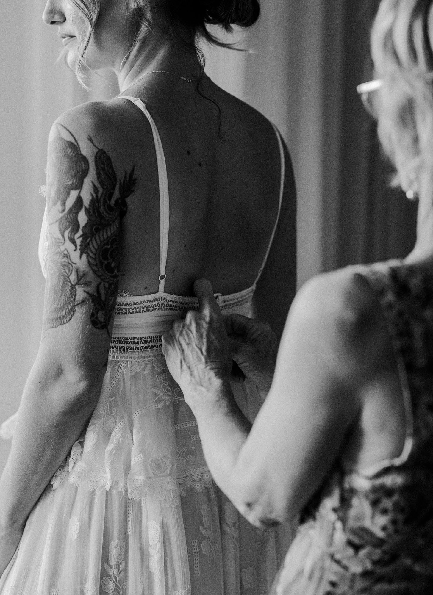 Terranea Resort bridal getting ready window lit candid putting on dress
