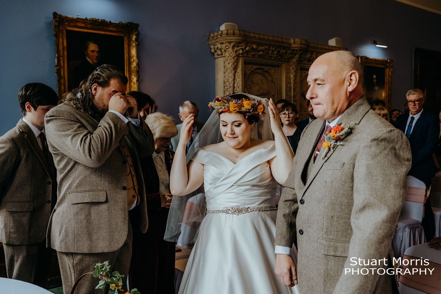 groom wipes his eyes as the bride walks up the aisle with her dad. Stuart Morris Photography.