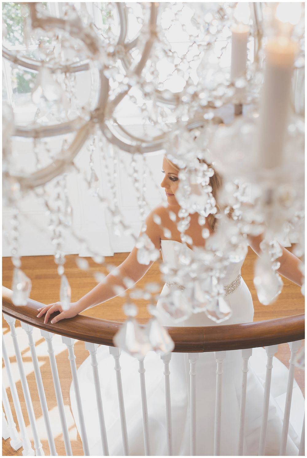 Crystal chandelier details with soft focus wedding scene beneath.