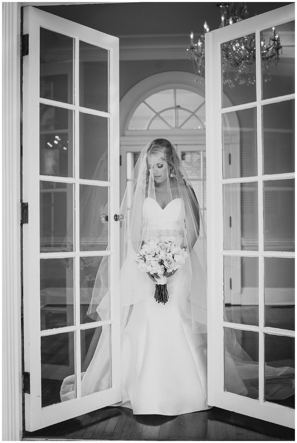 Black and white bridal portraits featuring elegant window frames and flowing white wedding gown.