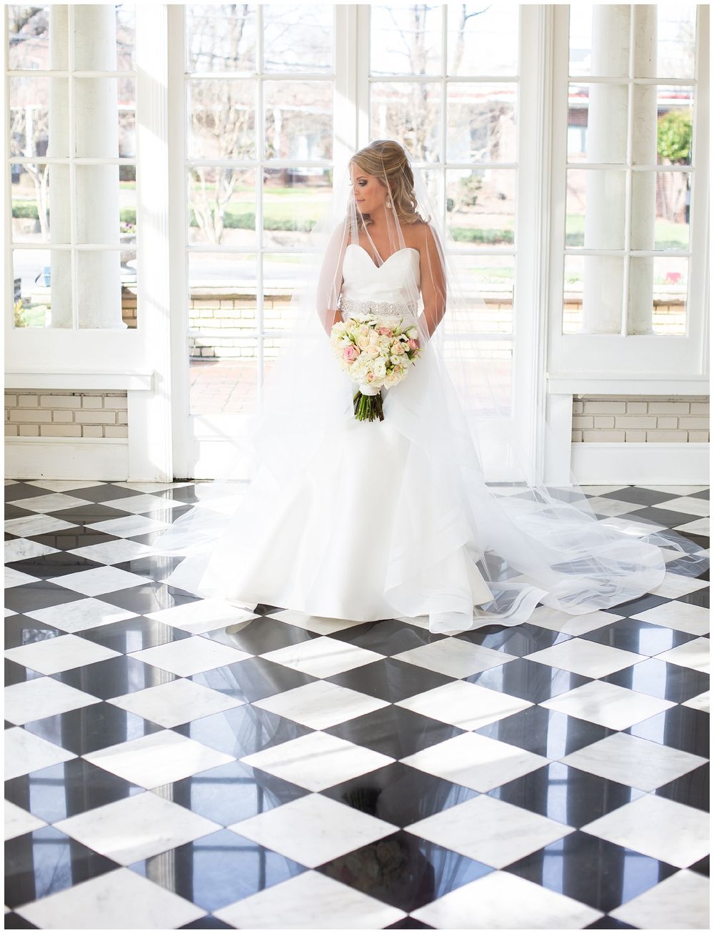 Wedding dress silhouette gliding across dramatic black and white checkered floor in bright sunlit room.