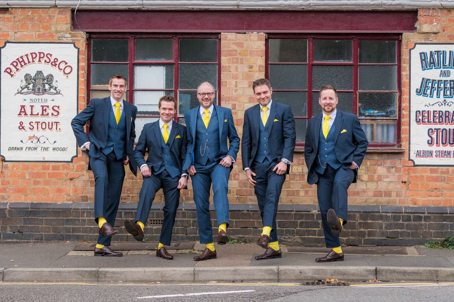 groomsmen showing their yellow socks, at Delapre Park, Northampton