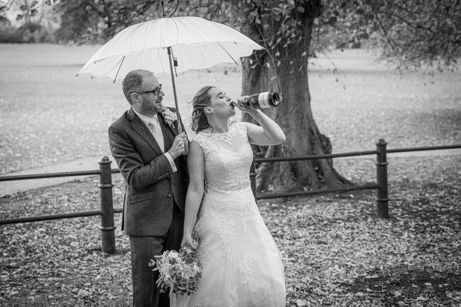 bride drinking champagn, at Delapre Park, Northampton