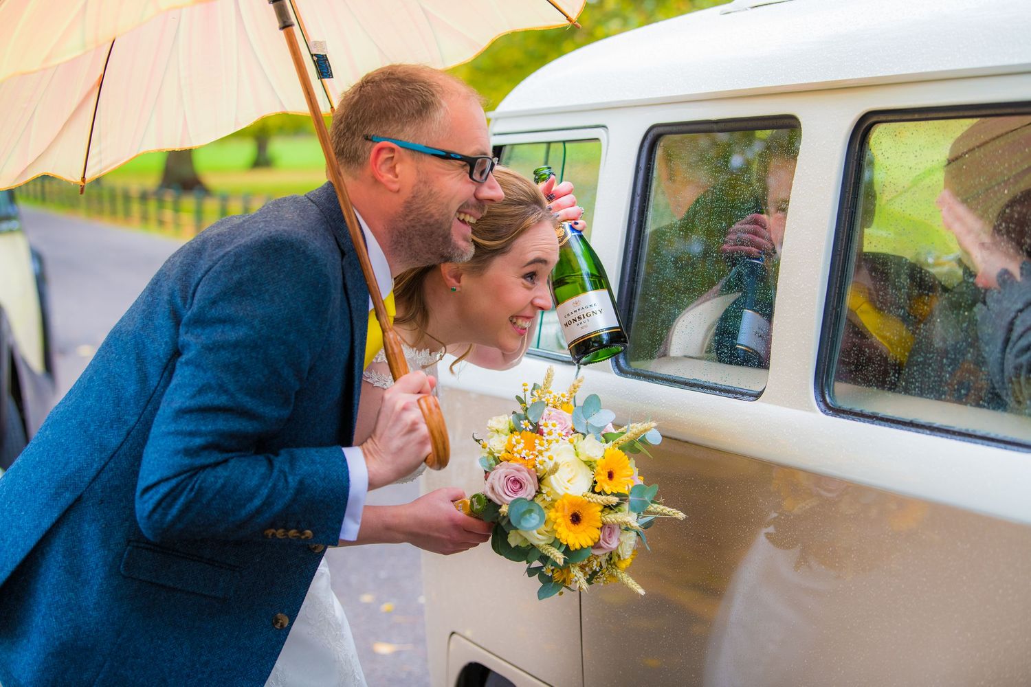 bride and groom with champaign next to camper van, at Delapre Park, Northampton