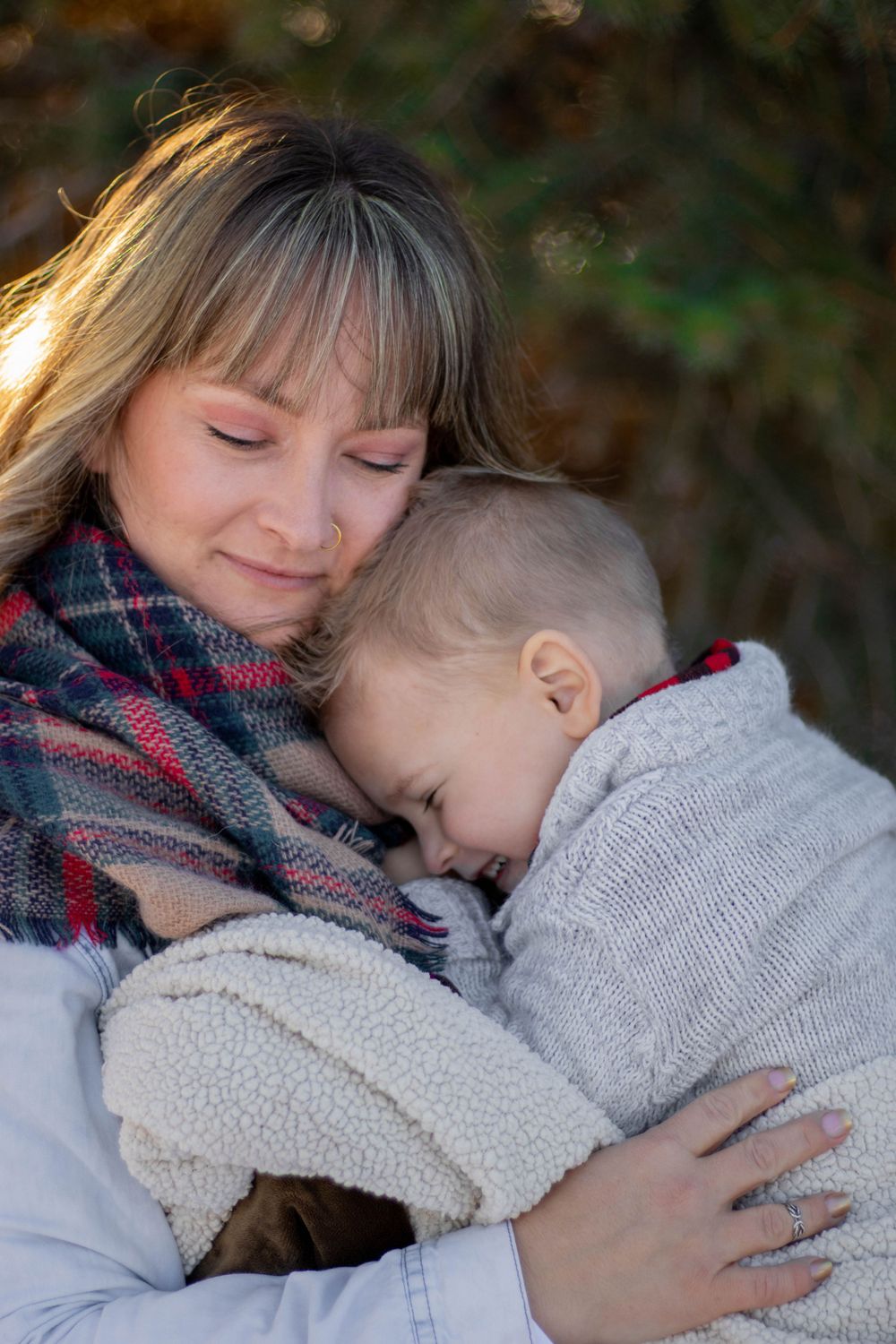 An intimate family moment showing affection and connection with a soft winter background.