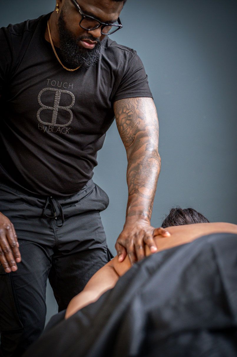 A masseur giving a therapeutic massage to a client.