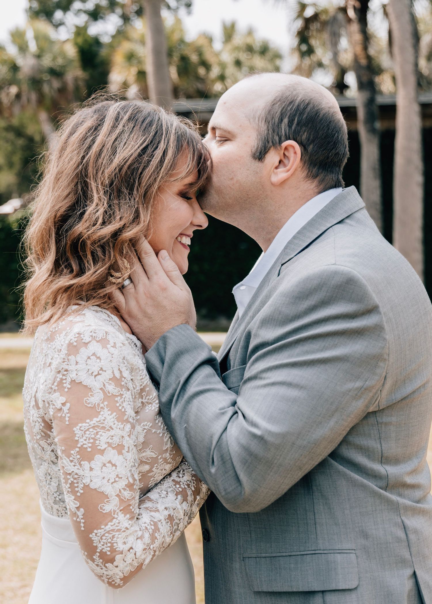 Romantic wedding couple sharing intimate moments in a garden setting.