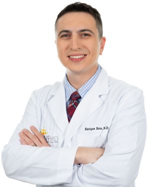 Medical professionals in white coats smile warmly while standing against a white background.