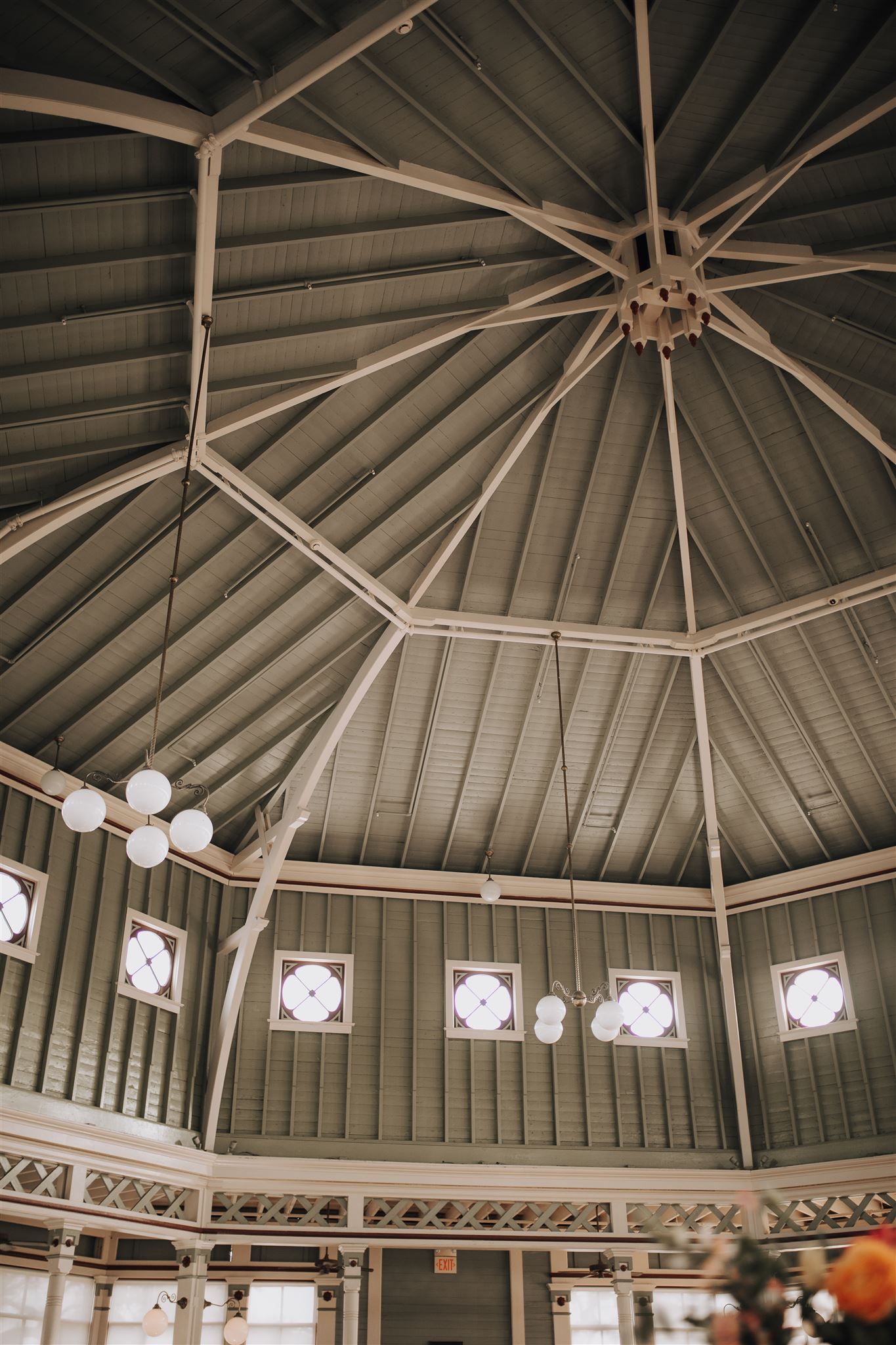 Ornate octagonal vaulted ceiling with vintage light fixtures in a historic building interior.