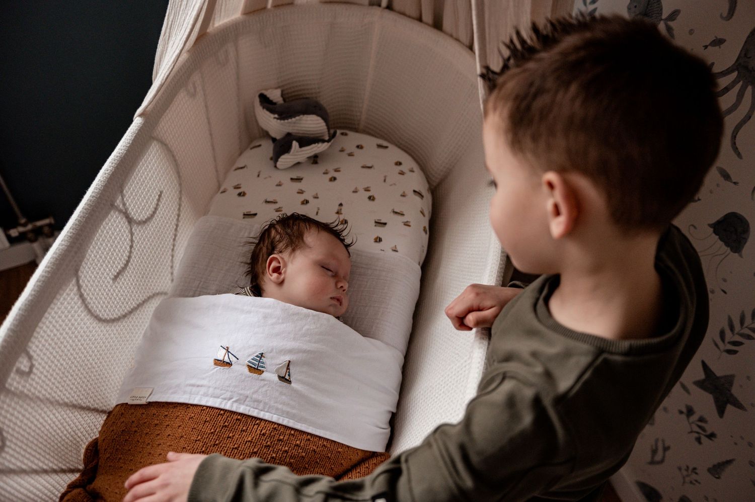 Candid family moments captured in black and white showing children at bedtime.