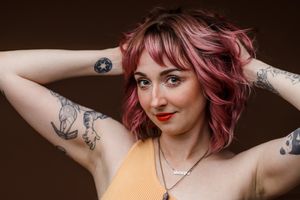 Gorgeous tatted woman posing for Cedar Park headshot photographer Pamela Clark of Perfectly Imperfect Photography