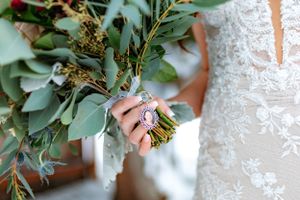 Capturing the memory of a bride's late mother from a cameo charm hanging from the brides bouquet