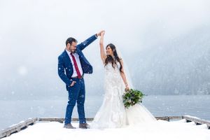 Bride and Groom dancing on snowy pier in Olympic Peninsula, WA during an elopement