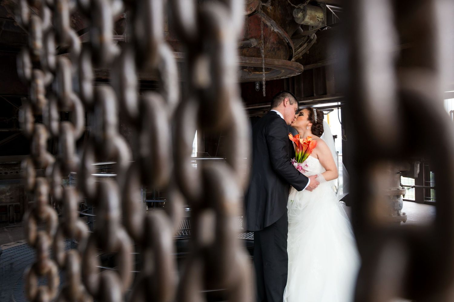 Romantic wedding moment captured through vintage iron gates.
