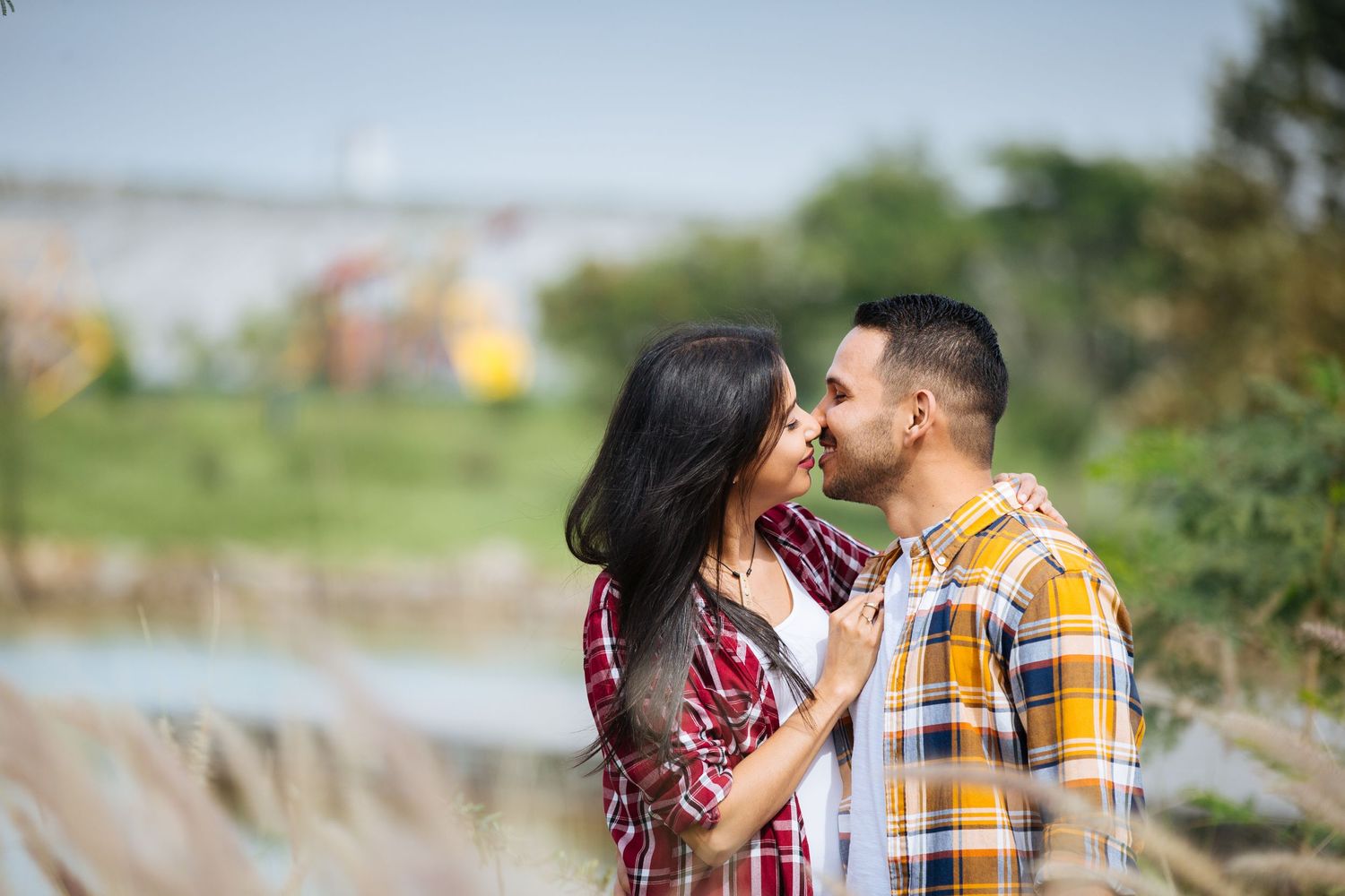 A tender autumn moment captured outdoors with natural scenery in the background.