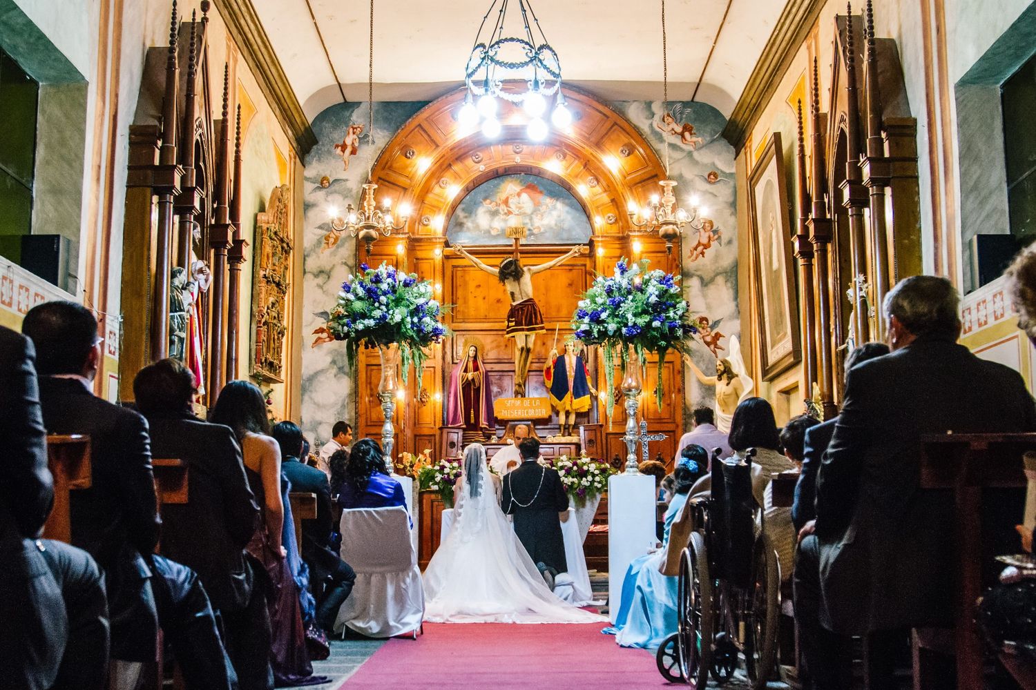 A traditional church wedding ceremony with elegant decor and stained glass windows.