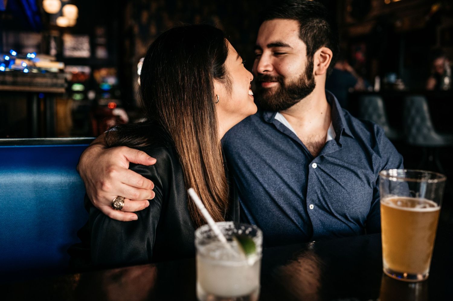 Cozy bar setting with cocktails and intimate lighting creating romantic ambiance.