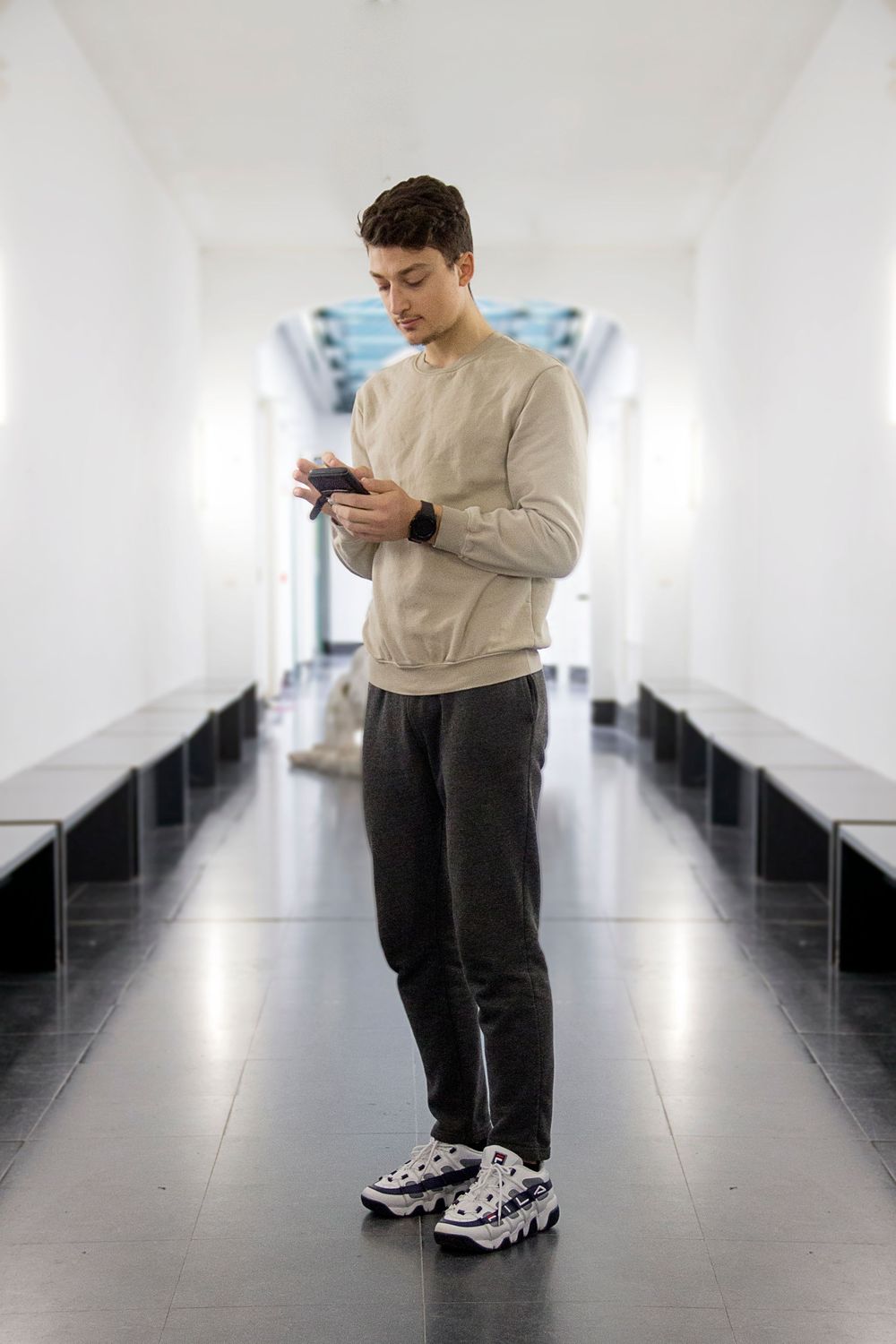 Omar texting in the hallway