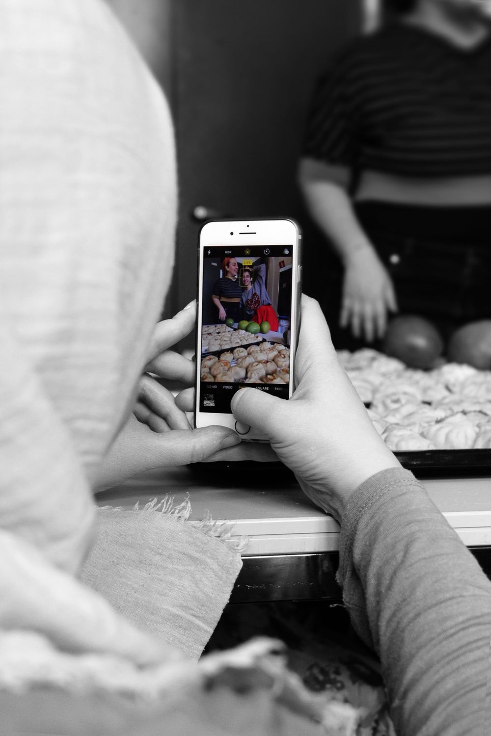 a photo of a phone of a table full of food. poco