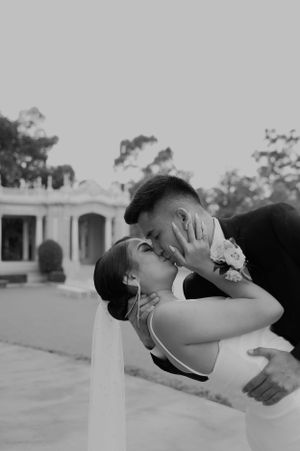 Dramatic dip pose captured in black and white during wedding photoshoot.
