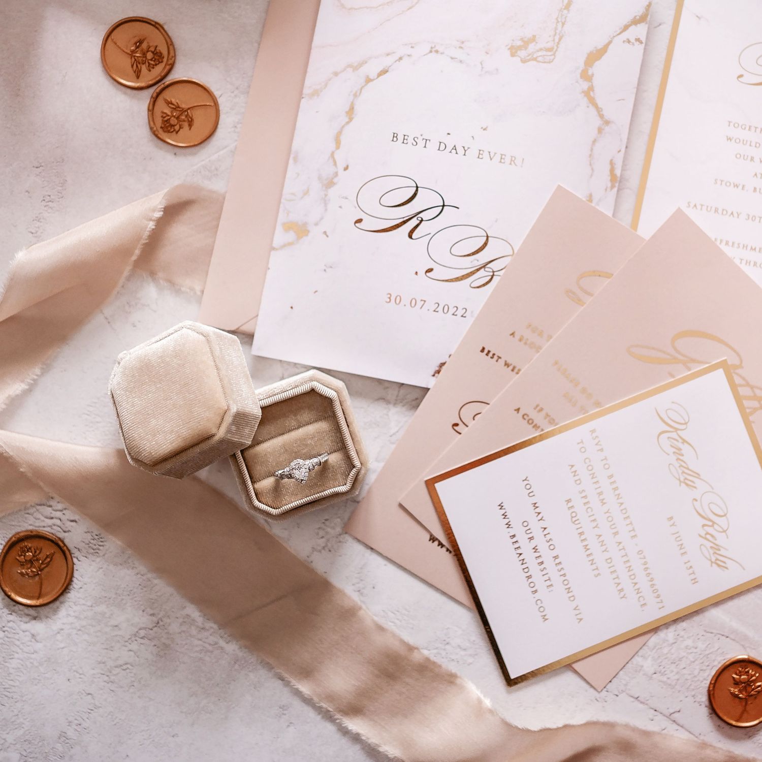 Wedding rings and stationery flat lay