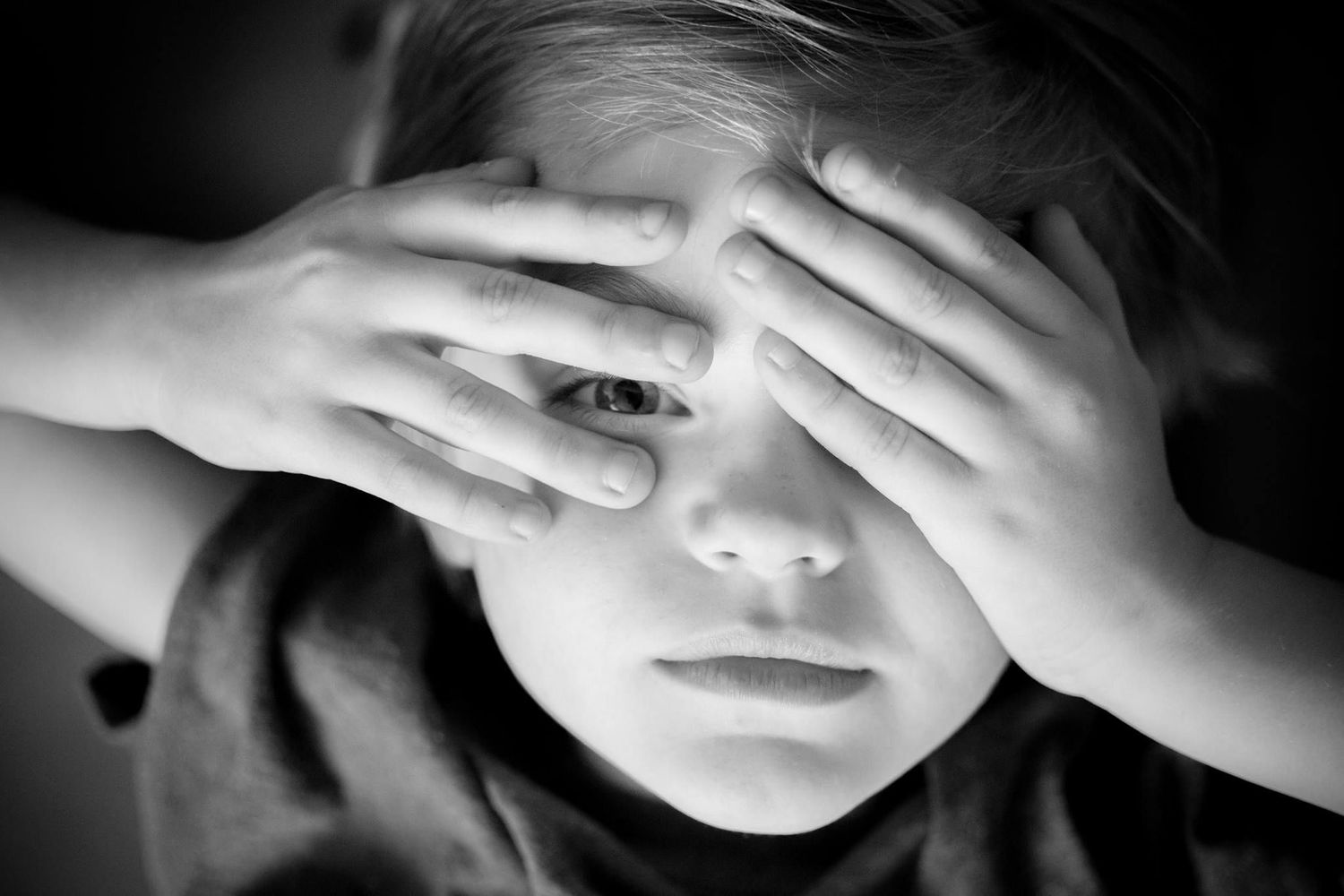 Dramatic black and white portrait series showing hands covering parts of the face.