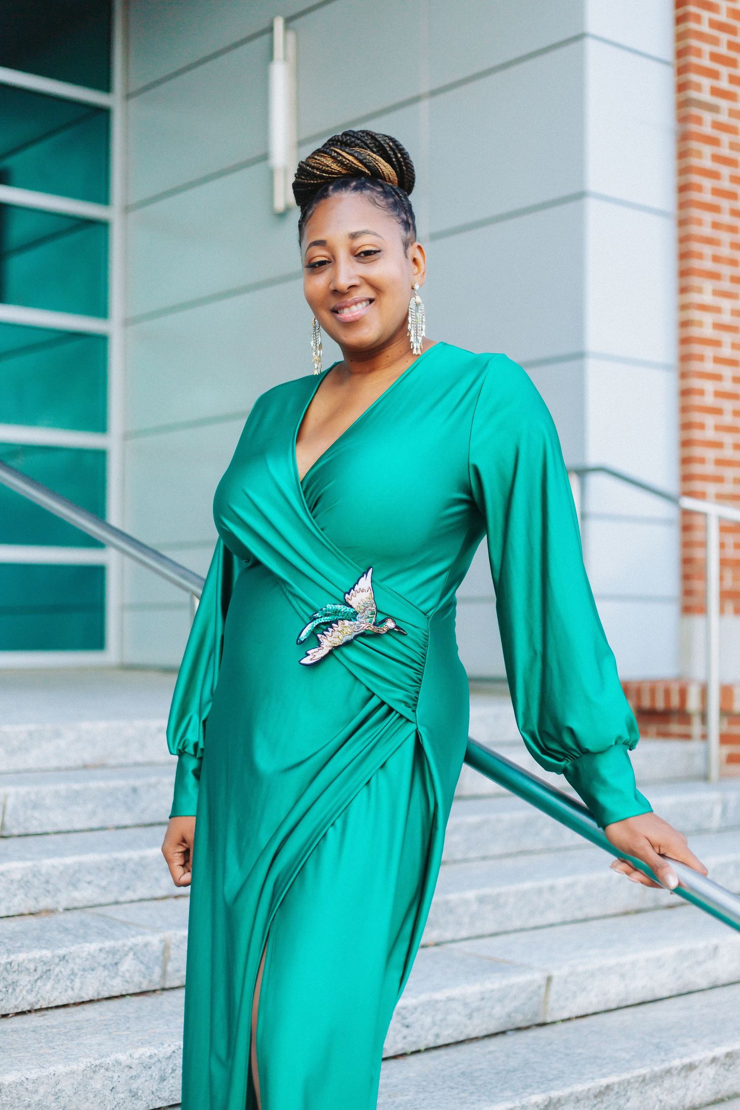 Stunning emerald green wrap dress with balloon sleeves and statement jewelry.
