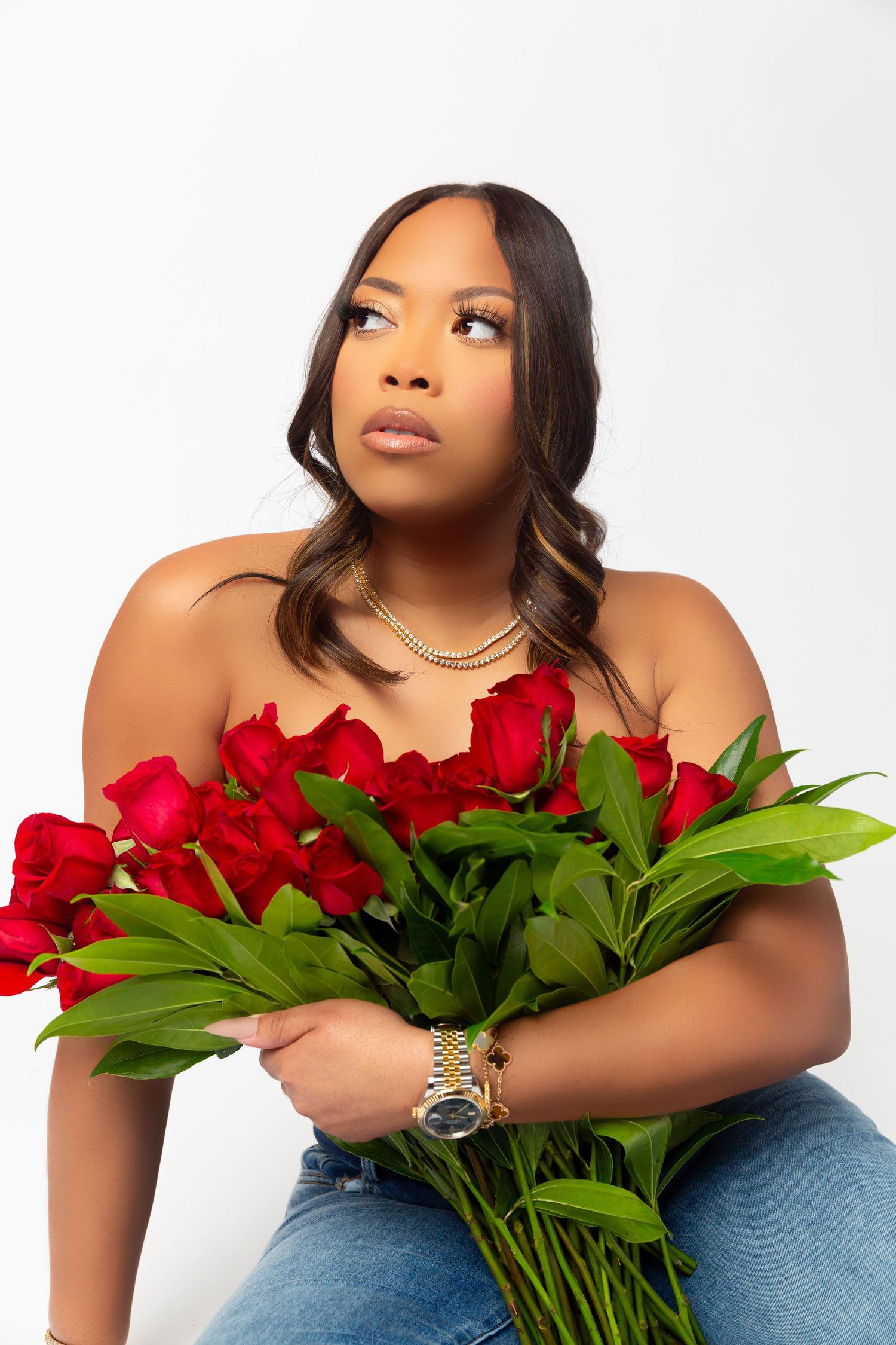 Portrait with beautiful red roses and greenery against white background.