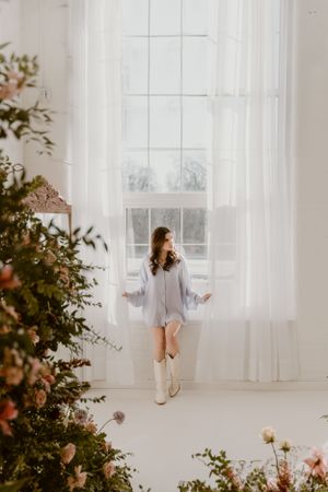 Winter indoor portrait with florals and flowing white curtains in the Hudson Valley,NY.