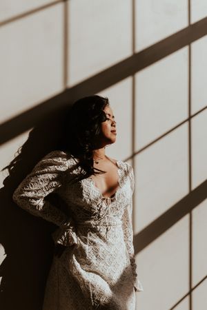 Dramatic side profile portrait with strong window light and shadows.