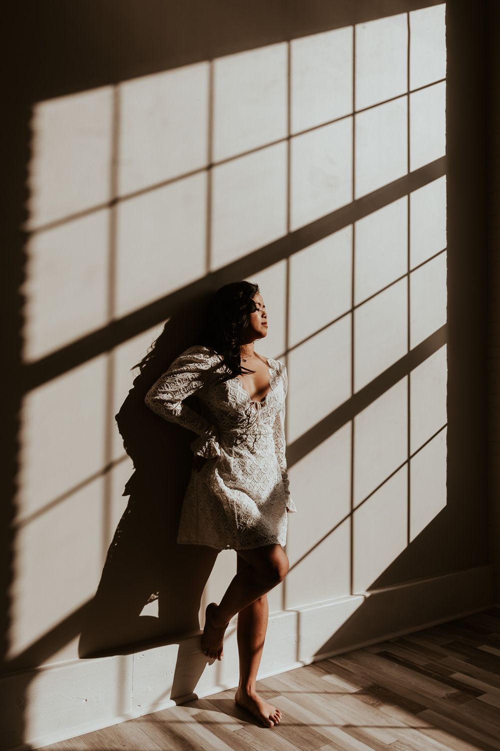 Artistic silhouette portrait with dramatic window shadow patterns in the Hudson Valley,NY.
