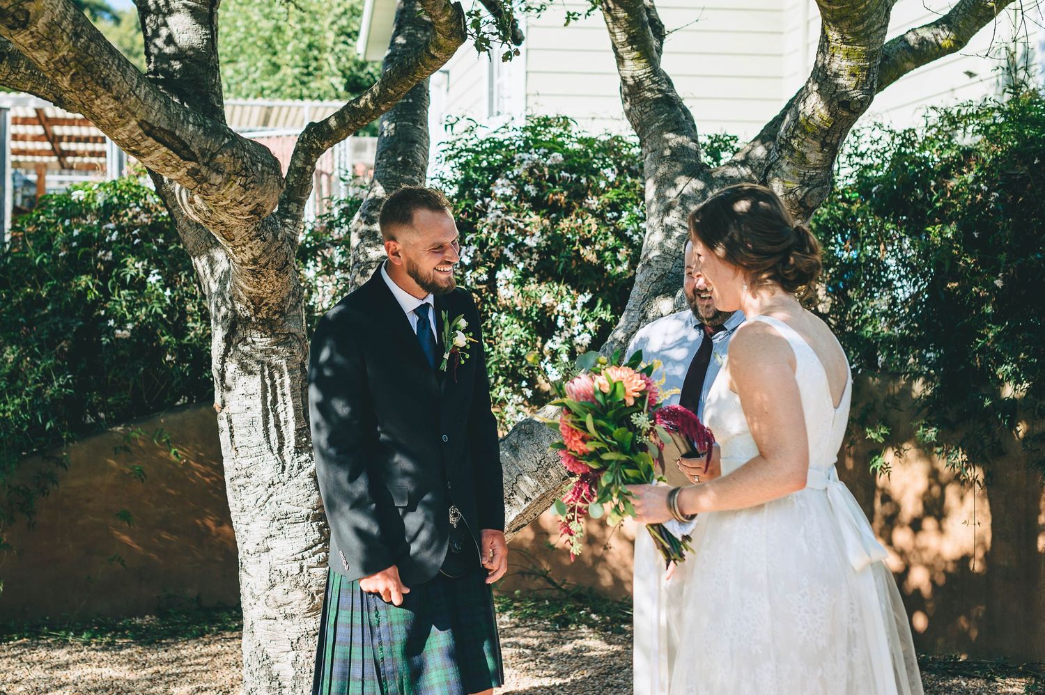 Bride and groom at small backyard wedding ceremony