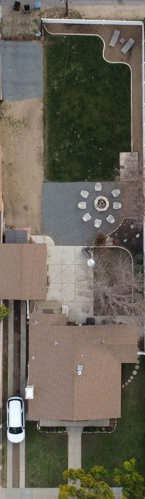 Aerial view of a residential property showing patios, lawn areas and outdoor furniture arrangements.