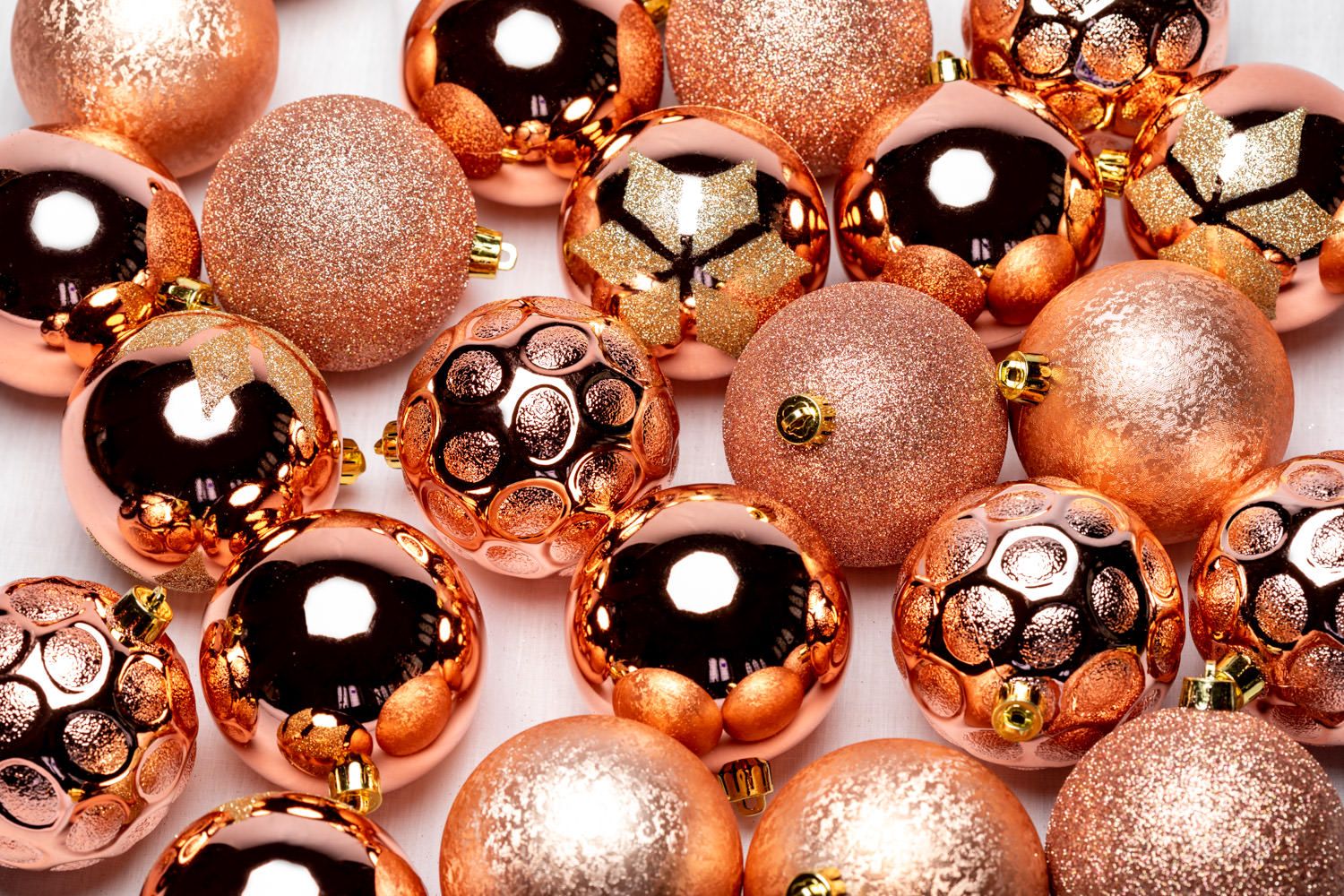 A product packshot of rose gold Christmas decorations by Danny Loo