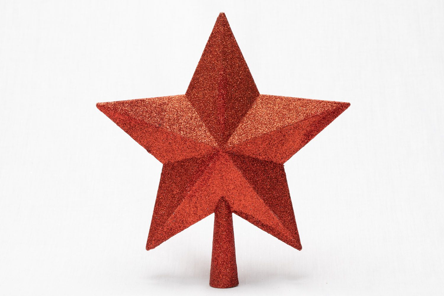 A product packshot of a red Christmas decoration by Danny Loo