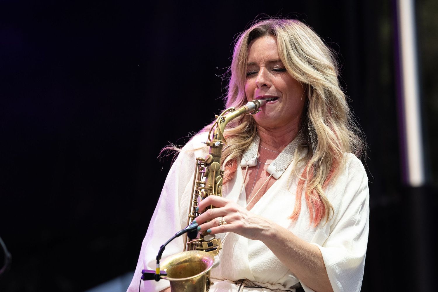Candy Dulfer performing a melodic solo on her saxophone at the Richmond Jazz & Music Festival