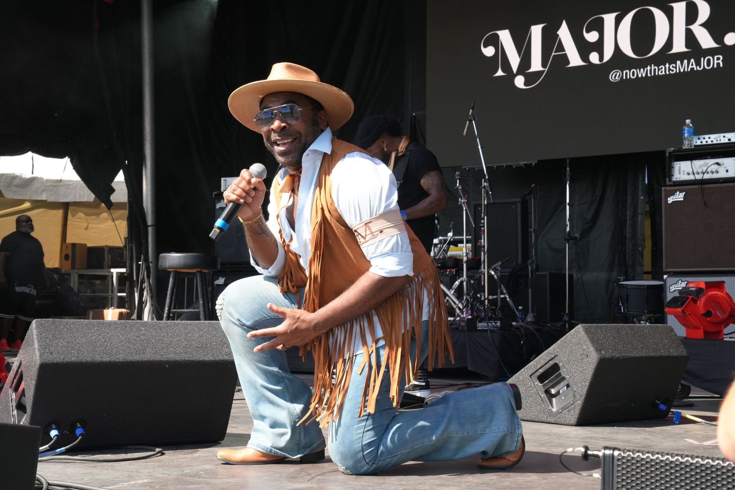 Close-up of MAJOR passionately singing into a microphone on stage