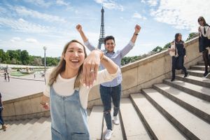 Joyful celebration on the steps of Trocadero with Eiffel Tower in background.