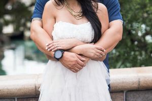 Romantic embrace captured against a blurred outdoor background.