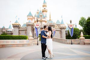 A romantic photoshoot in front of Disneyland's iconic Sleeping Beauty Castle.