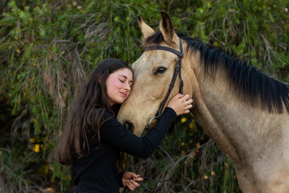 Lexie and her boy Mighty at their horse and rider session, sharing a cuddle.
