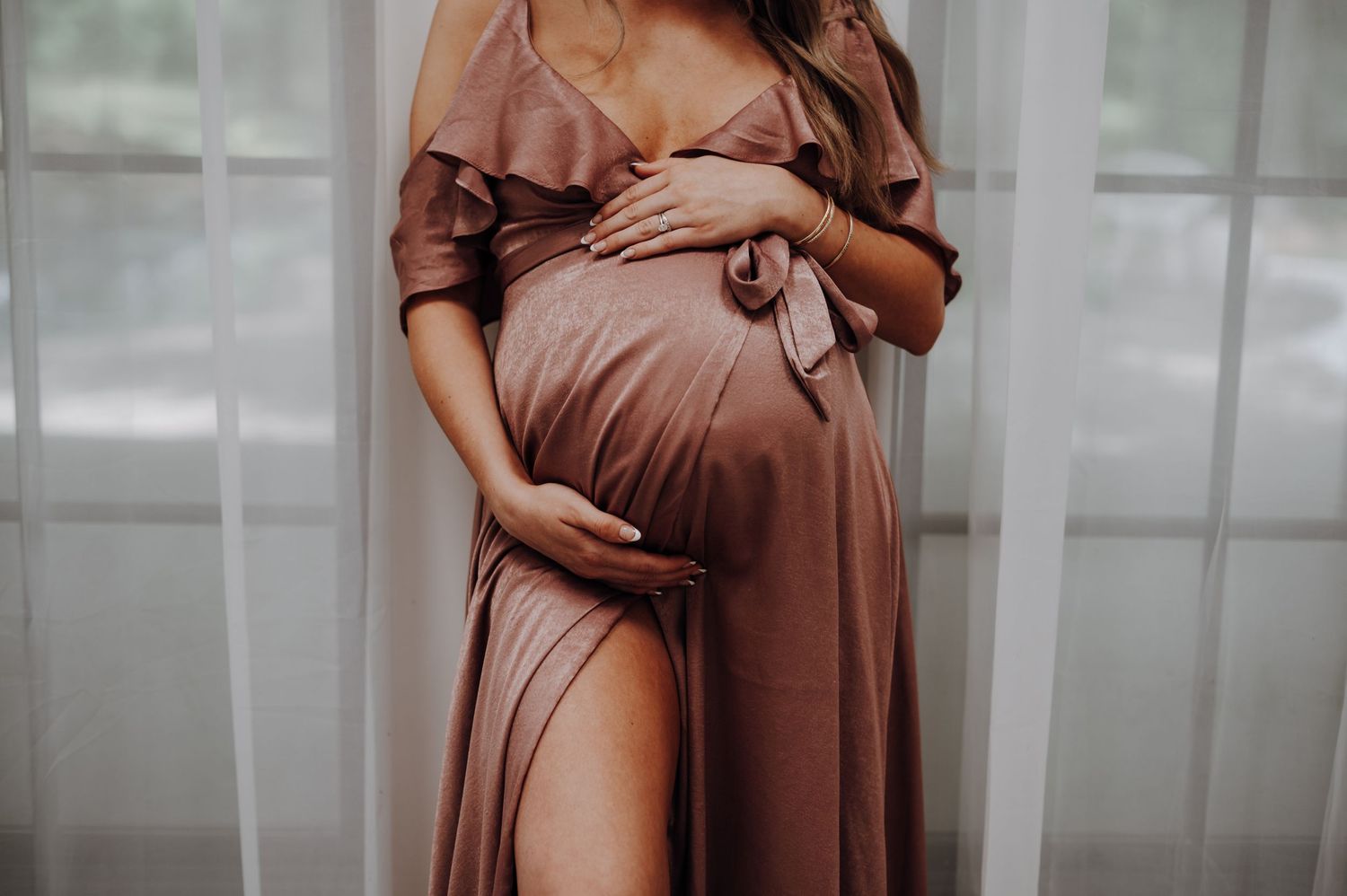 Mother-to-be maternity session at Oak Atelier in Conroe, Tx. Dress is rose-colored satin from Lulu's.