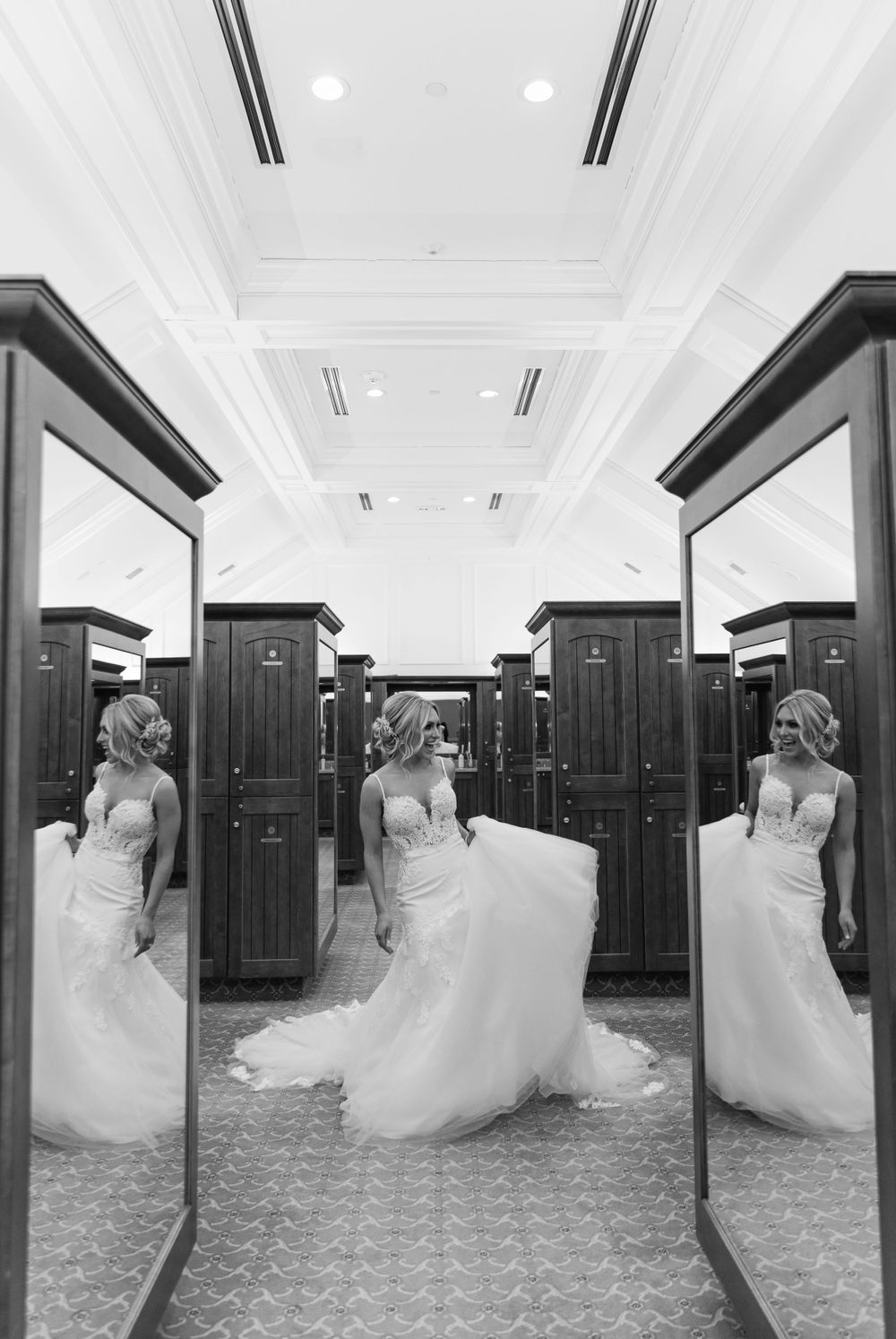 Artistic black and white photo of bride in wedding dress reflected in three mirrors.