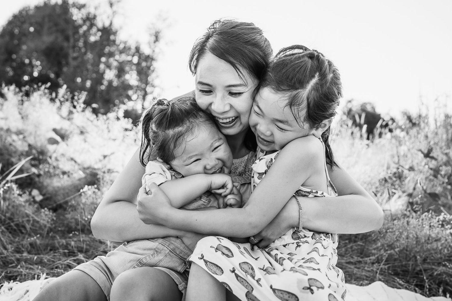 Redmond Family Photographer, mother hugging daughters, black and white image