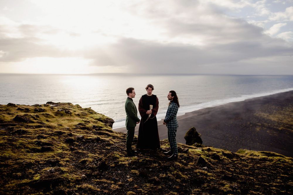 Small gathering on a dramatic coastal clifftop at sunset.