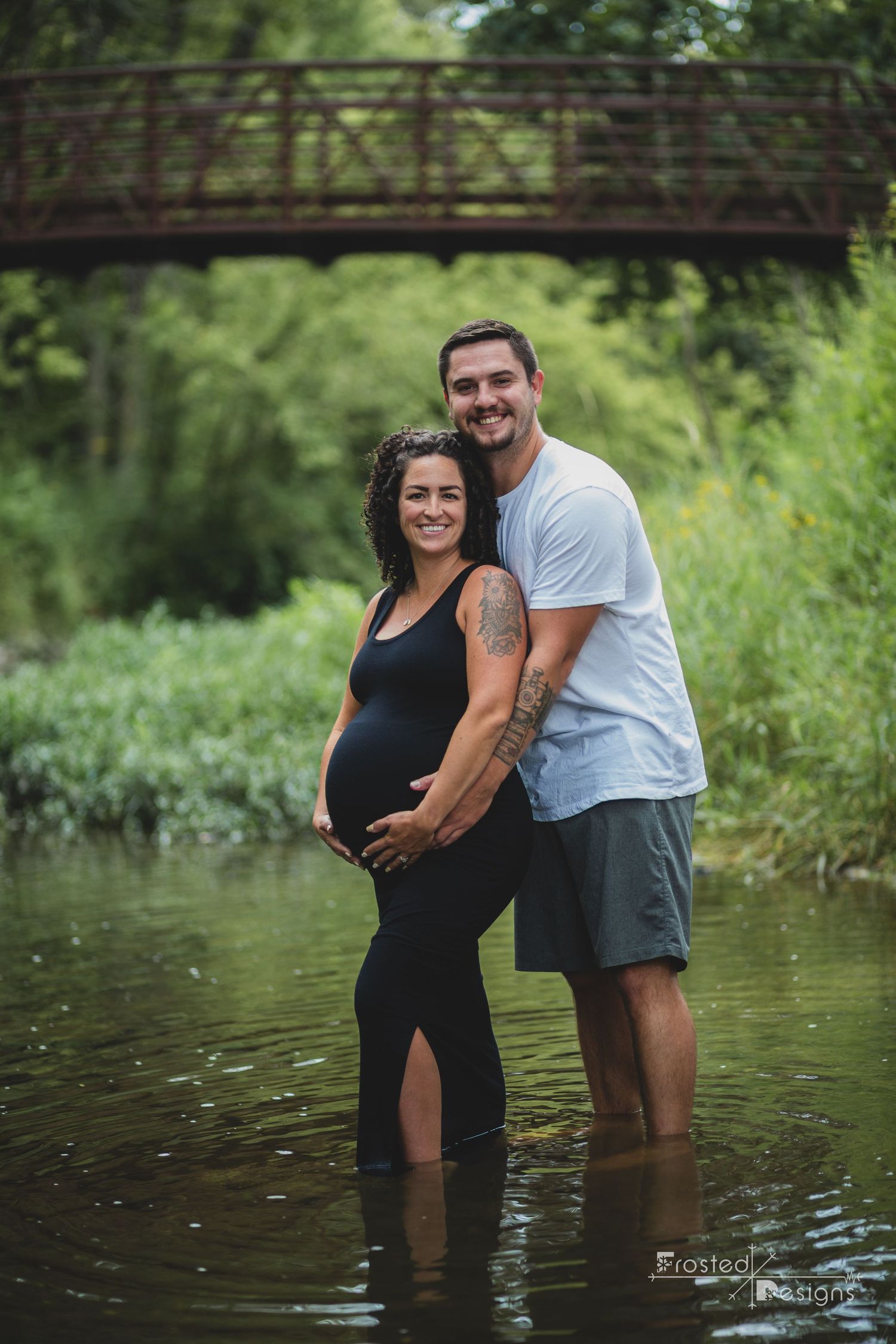 Mom and Dad expectant with a daughter in creek at Arbuckle Acres Park.