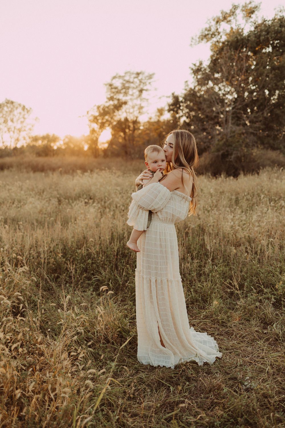 sweet sweet cuddle in the field with mom during family photography session